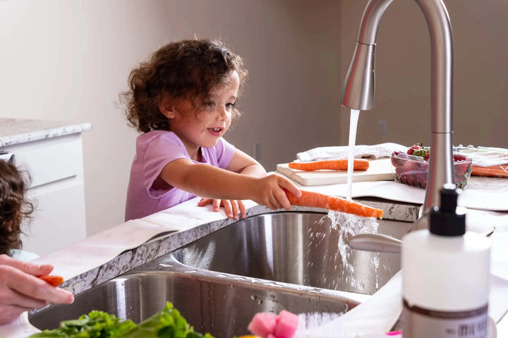 Cute Girl Washing a Carrot with a Splashpad Faucet Handle Drip Catcher