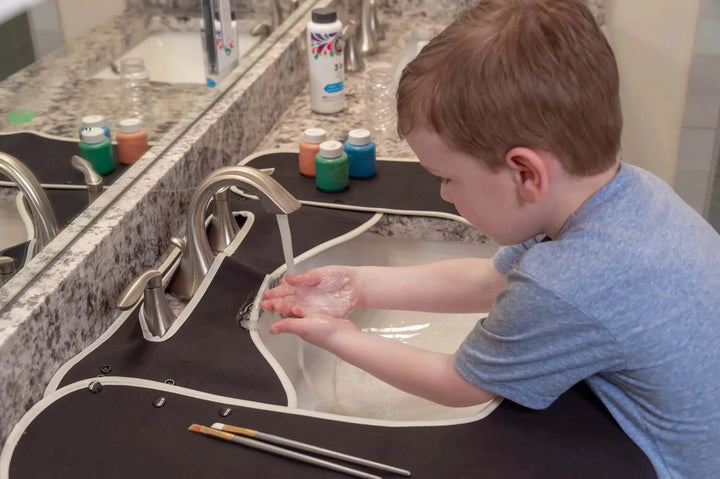 Boy Washes His Hands at the Sink after Art and the Splashpad Keeps His Counter Clean and Dry - Kids Bathroom Mat Black