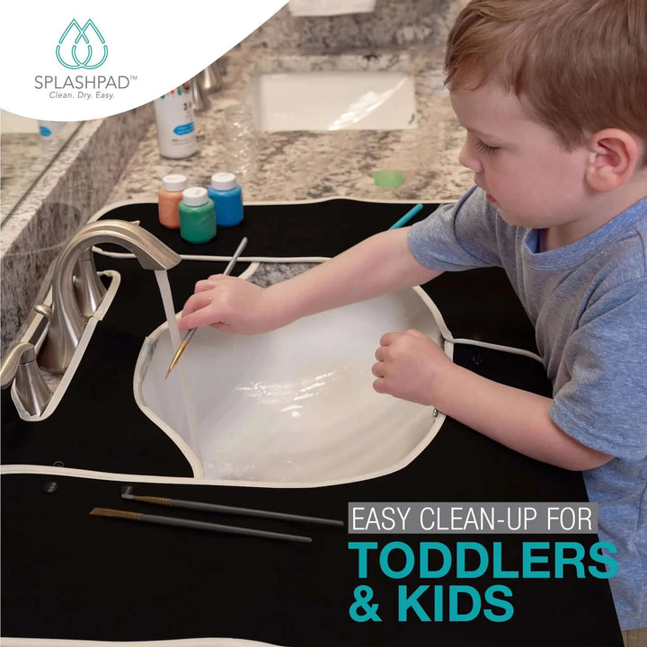 Boy Washes His Art Brushes at the Sink with a Kids Bathroom Sink Splash Guard - Black Splashpad Mat