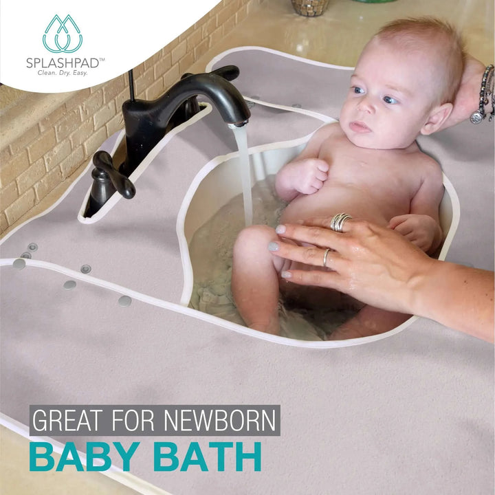 Newborn Baby Sink Bath in the Bathroom with a Grey Splashpad Mat
